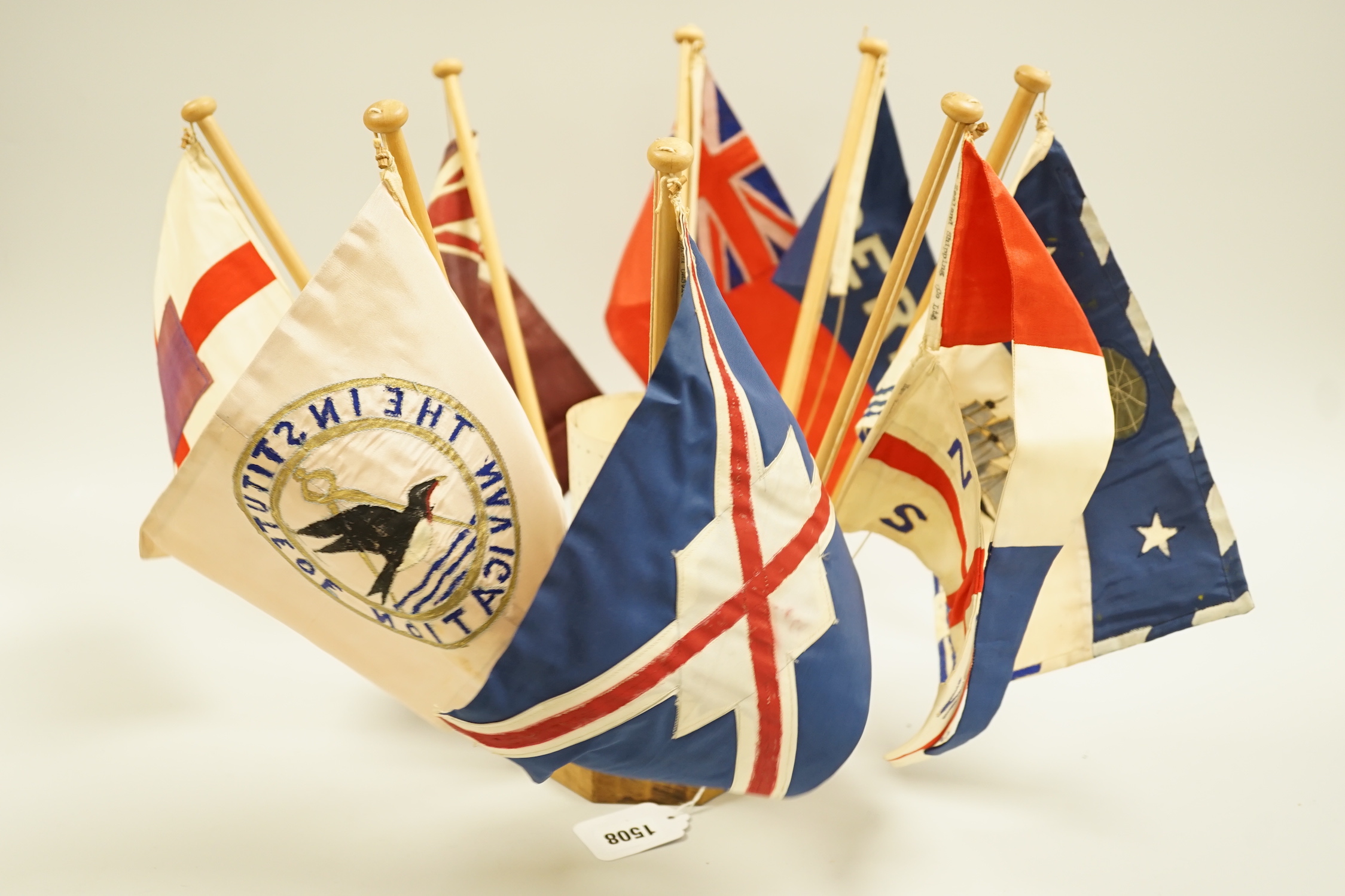 A collection of shipping flags on a stand and a boxed silver oar, engraved: 2nd, Destroyer Flotilla Regatta 1934, 29.5cm long